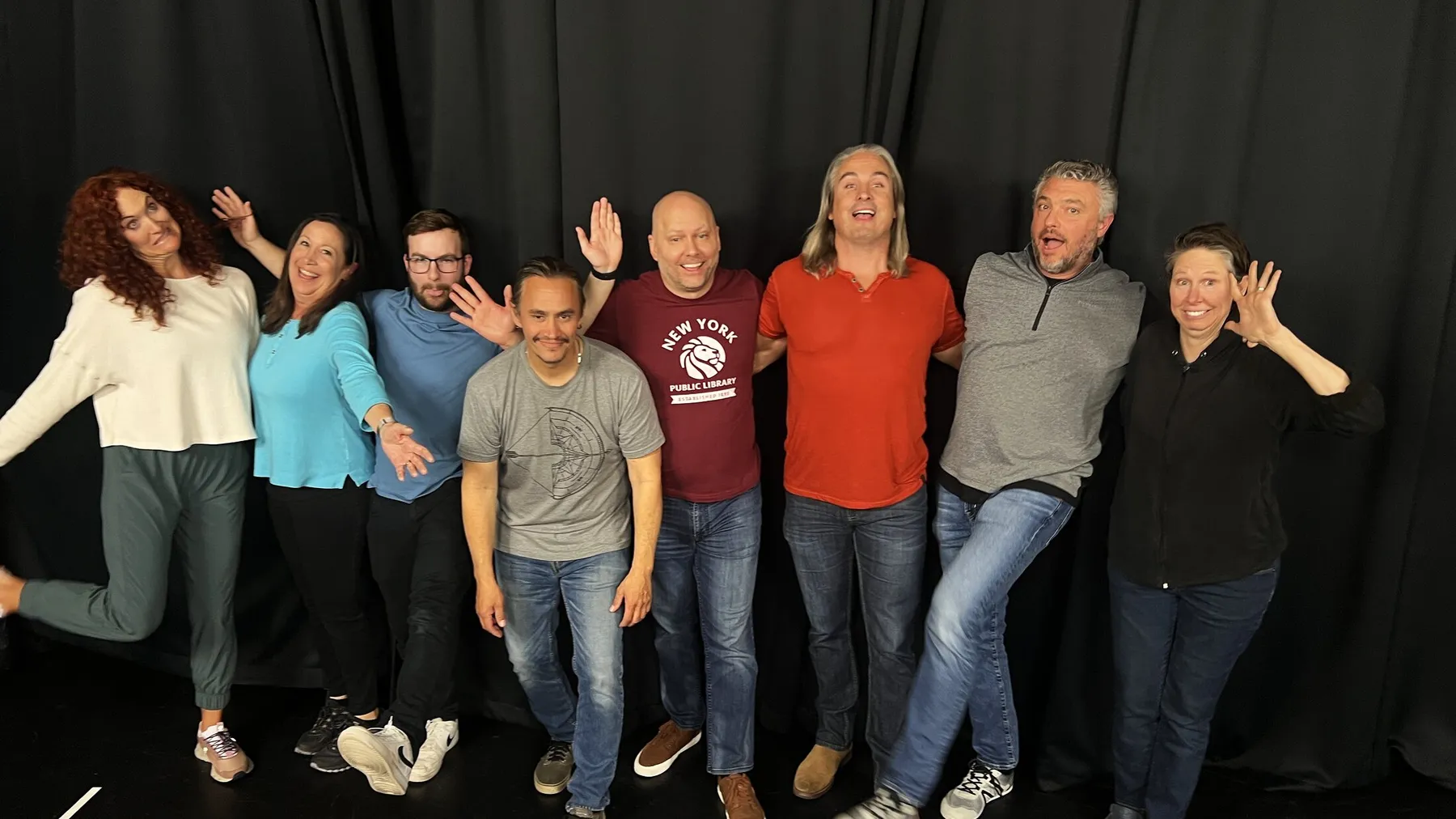 Eight actors on the black curtain at the end of a callback session in the Phoenix suite