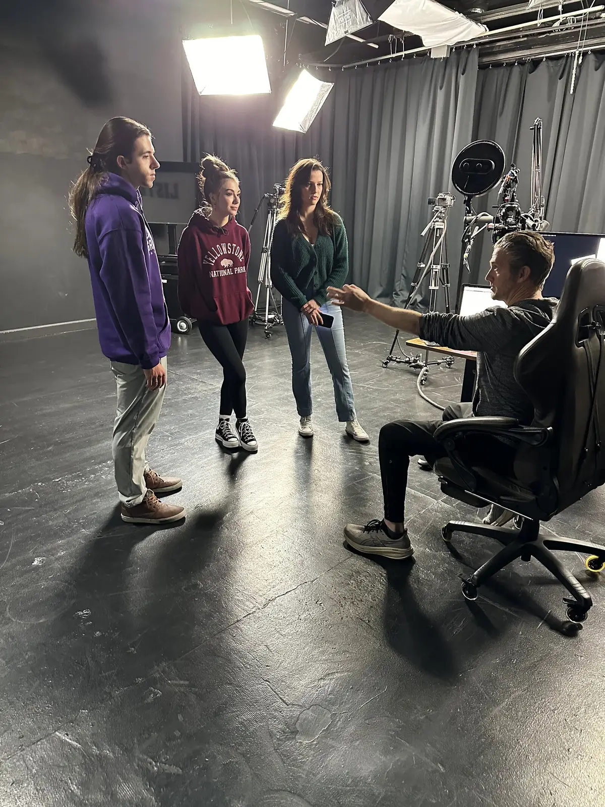 Matthew Dearing directing three actors under the lights at a Phoenix Casting session