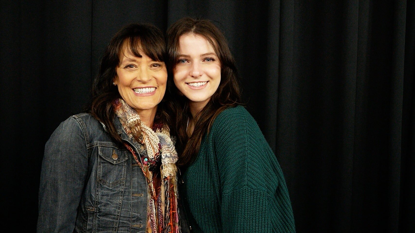 A mother and daughter at a callback, on the black curtain