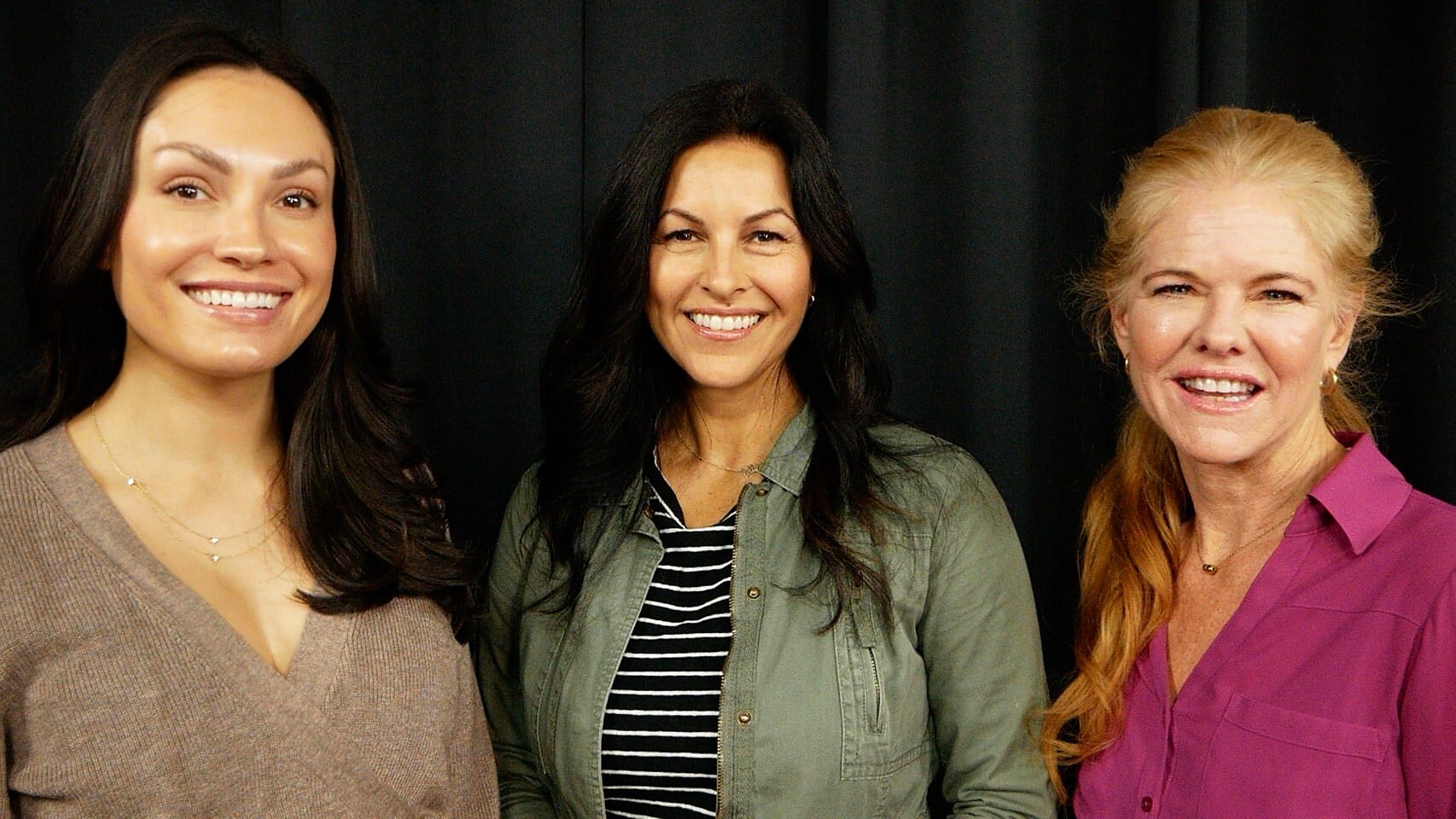 Three women at a callback, on the black curtain