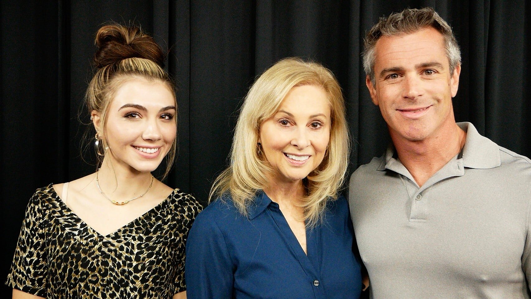 A family of three at a callback, on the black curtain